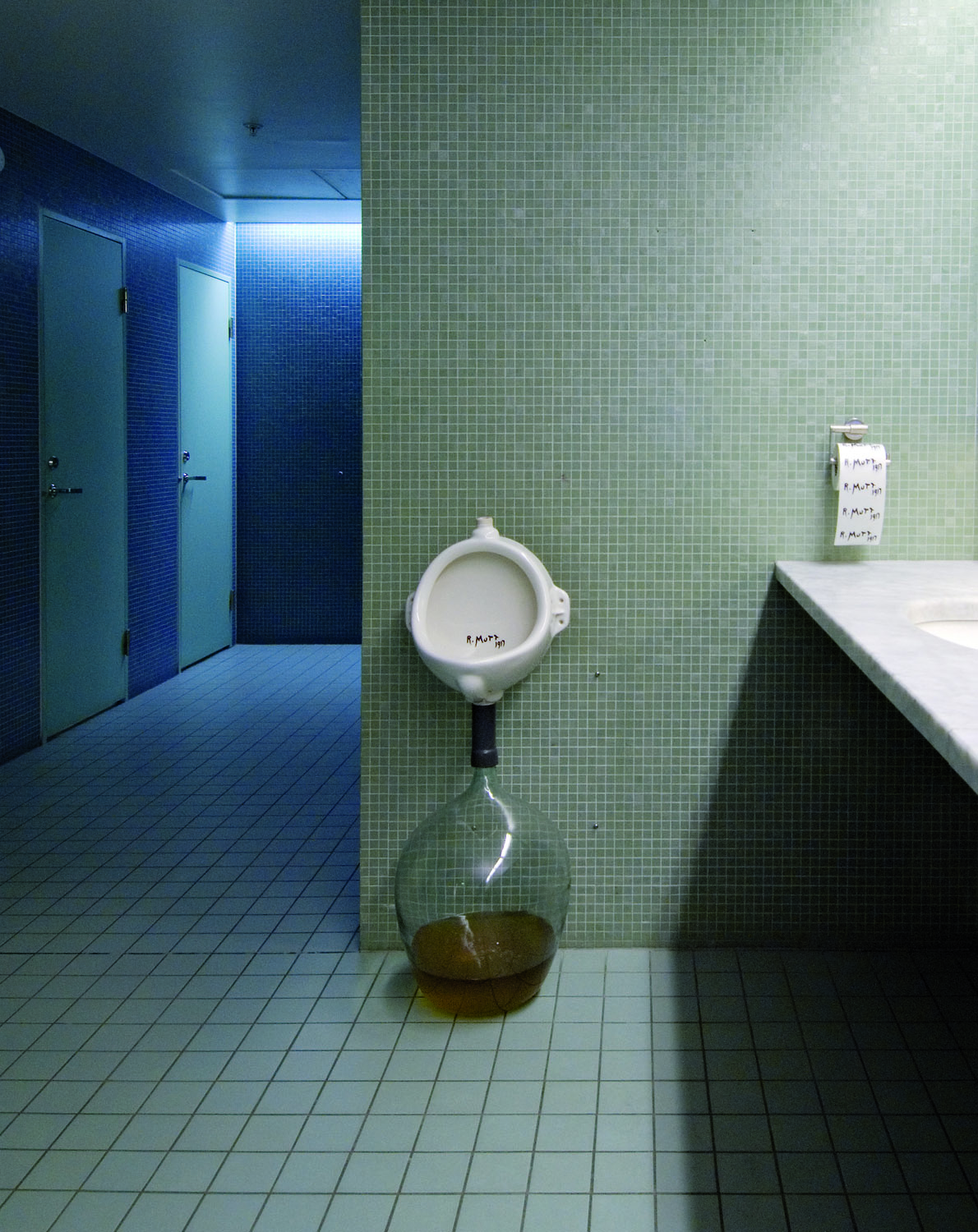 Already Made 3 (Pissoir), 2007. Glass bottle, tube, urinal. Installation view, Moderna Museet, Stockholm. Photo: Åsa Lundén. Courtesy of the Artericambi/Pandian Collection.